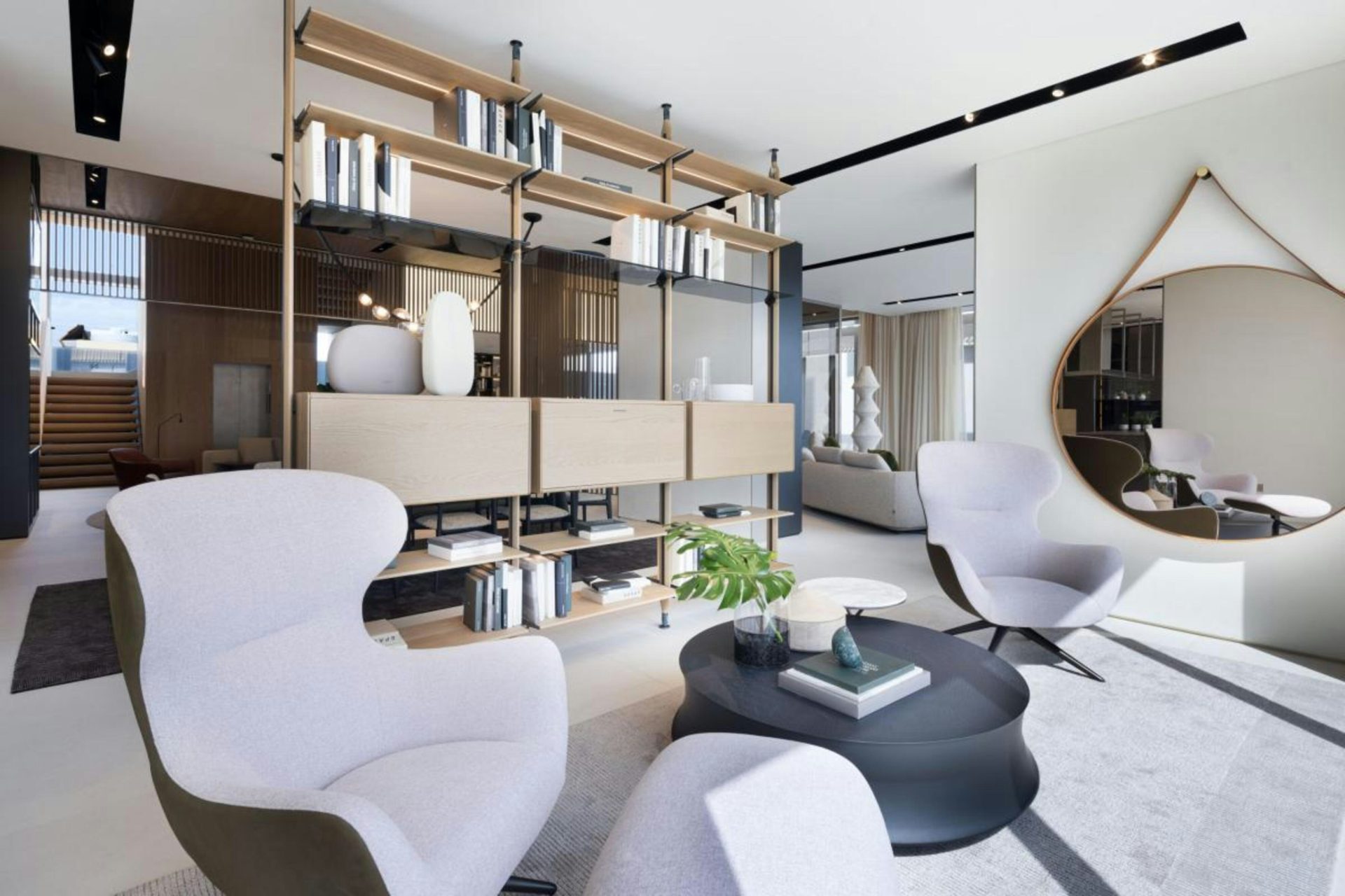 Modern living room with stylish furniture and shelving.